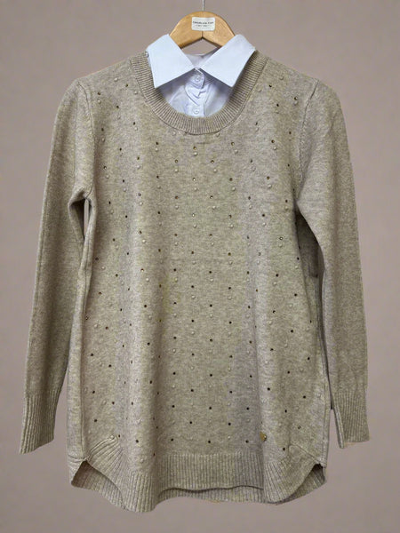 Beige sweater with a white shirt collar on a hanger against a white background