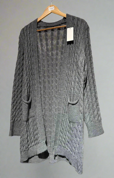 Gray cable knit cardigan on a hanger against a neutral background