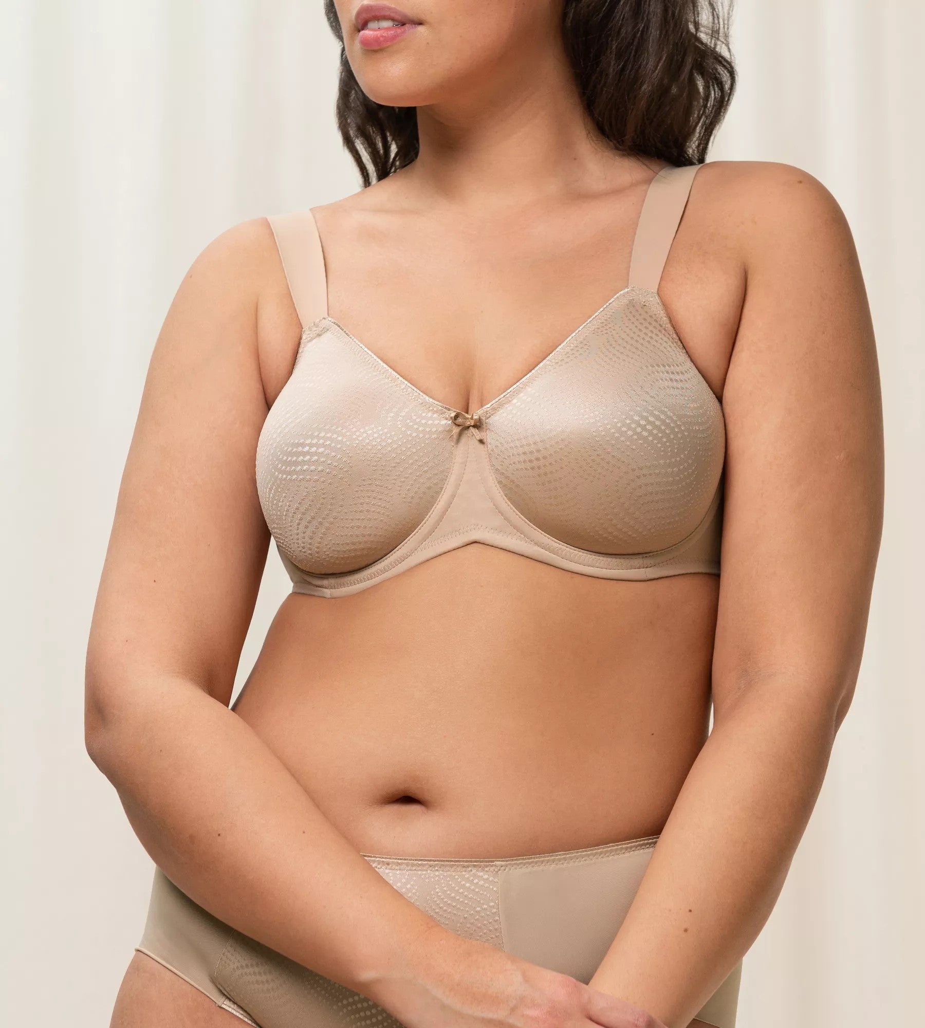  a beige Triumph minimizer bra with adjustable straps.
