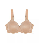 A woman wearing a beige Triumph minimizer bra with adjustable straps.
